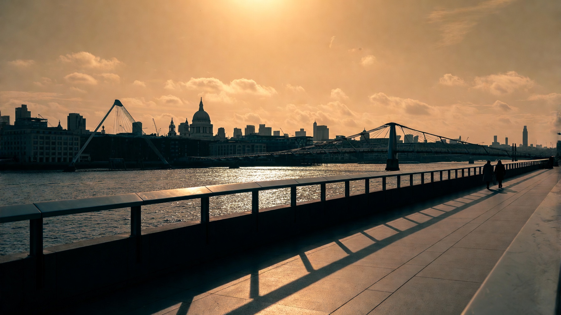South Bank walkway at golden hour with the Thames and Millennium Bridge
